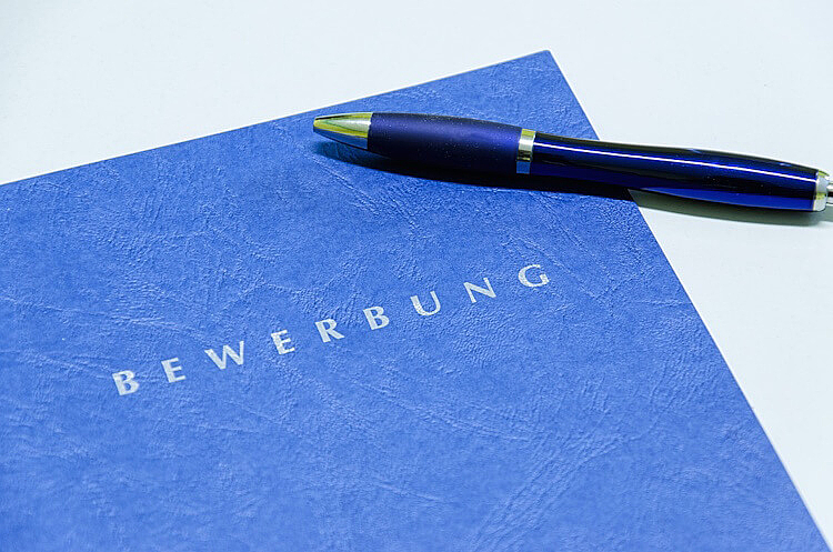 Bewerbungsmappe und Stift